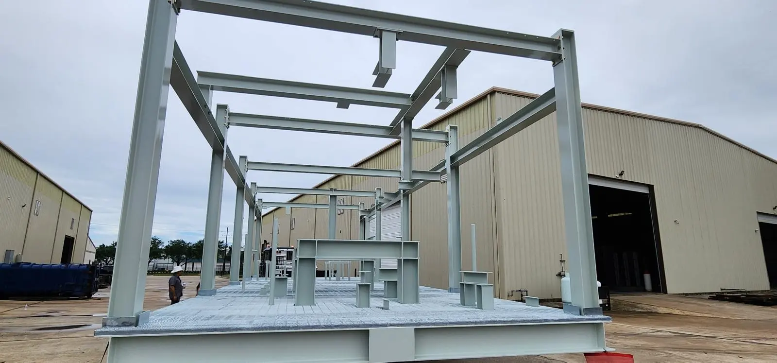 Painted structural steel module frame fabricated by DJM, staged outside the shop
